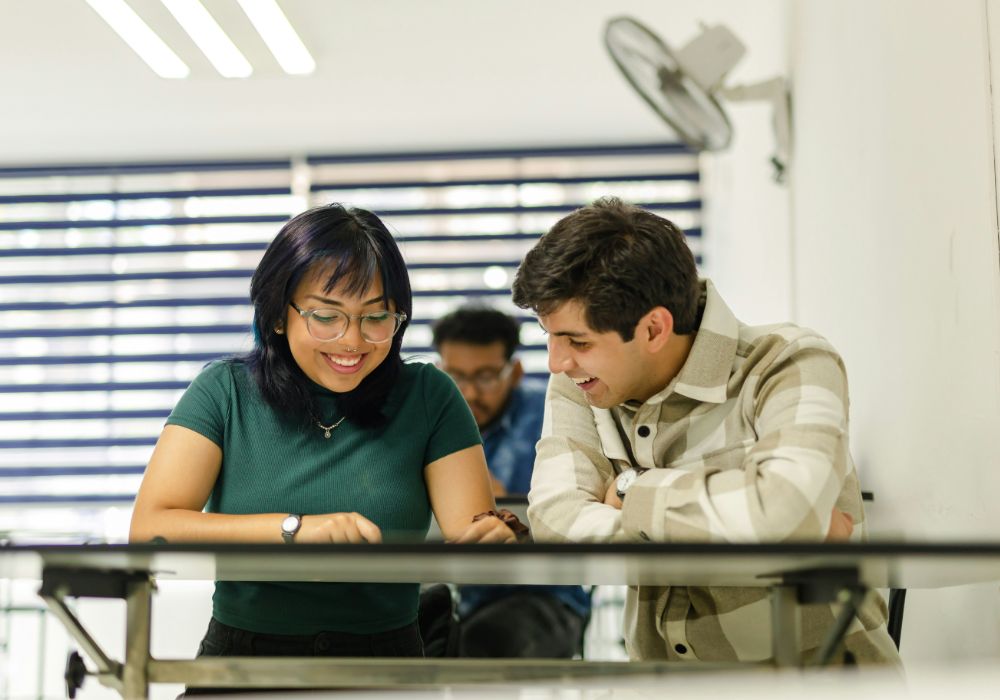 A man and a woman looking at a book.
