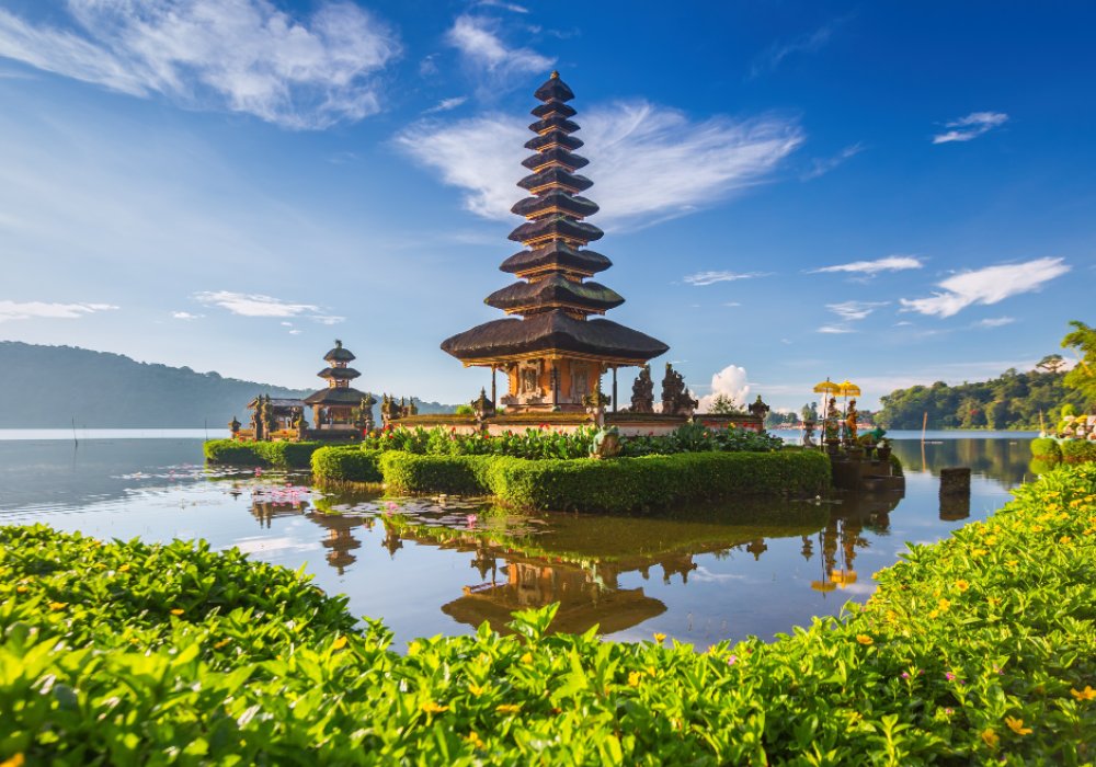 Indonesian temple reflected in the calm waters of a lake in Bali.