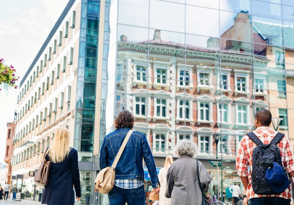 People strolling together along a street.